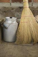 The milk jar and broom. Retro style. photo