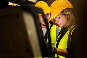 Factory engineer woman standing confidence to control panel switch. Worker works at heavy machine at industry factory. with machinery equipment plant technology. smart industry worker operating. photo