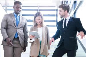 Business people shaking hands. finishing up a meeting. team of business people walk in rush hour at indoor pedestrian stairs and talk together. concept negotiations in feeling successful and happy. photo