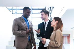 Business people shaking hands. finishing up a meeting. team of business people walk in rush hour at indoor pedestrian stairs and talk together. concept negotiations in feeling successful and happy. photo