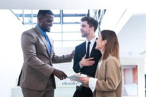 Business people shaking hands. finishing up a meeting. team of business people walk in rush hour at indoor pedestrian stairs and talk together. concept negotiations in feeling successful and happy. photo