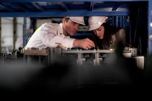 checking and inspecting metal machine part items for shipping. male and woman worker checking the store factory. industry factory warehouse. The warehouse of spare part for machinery and vehicles. photo