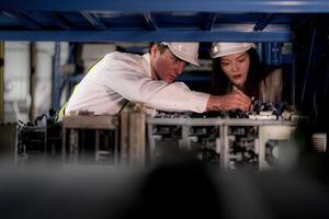 technician engineers team checking the machine and maintenance service. workers looking at spare parts in stock at warehouse factory. laborer with a checklist looking on part of machine parts. photo