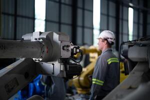 engineers check control heavy machine robot arm. Diverse Team of Industrial Robotics Engineers Gathered Around Machine. Professional Machinery Operators repair electric robot on bright digital panel. photo