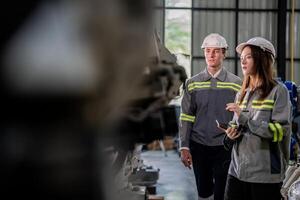 engineers check control heavy machine robot arm. Diverse Team of Industrial Robotics Engineers Gathered Around Machine. Professional Machinery Operators repair electric robot on bright digital panel. photo