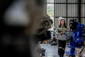 engineers check control heavy machine robot arm. Diverse Team of Industrial Robotics Engineers Gathered Around Machine. Professional Machinery Operators repair electric robot on bright digital panel. photo