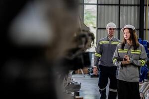 engineers check control heavy machine robot arm. Diverse Team of Industrial Robotics Engineers Gathered Around Machine. Professional Machinery Operators repair electric robot on bright digital panel. photo