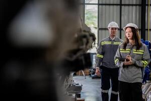 engineers check control heavy machine robot arm. Diverse Team of Industrial Robotics Engineers Gathered Around Machine. Professional Machinery Operators repair electric robot on bright digital panel. photo