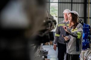 engineers check control heavy machine robot arm. Diverse Team of Industrial Robotics Engineers Gathered Around Machine. Professional Machinery Operators repair electric robot on bright digital panel. photo