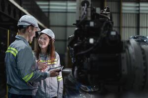 engineers check control heavy machine robot arm. Diverse Team of Industrial Robotics Engineers Gathered Around Machine. Professional Machinery Operators repair electric robot on bright digital panel. photo