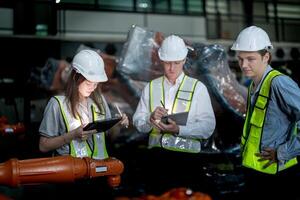 Sales manager and factory owner in suits negotiating selling robots used in the factory. Business engineers meeting and checking new machine robot. Workers walking at warehouse welding machine. photo