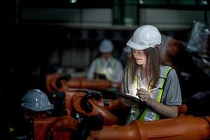 negocio ingenieros reunión y comprobación nuevo máquina robot. trabajadores caminando a almacén industria soldadura máquina. negocio negociación conceptos y tecnología. mujer utilizando inteligente tableta a presente hombre. foto