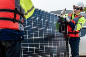 Workers Technicians are working to construct solar panels system on construction site. engineers are checking before Instal solar photovoltaic panel system. Renewable clean energy technology concept. photo