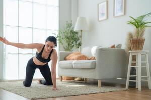 close up women confident training yoga. Athletic women in sportswear doing fitness stretching exercises at home in the living room. Sport and recreation concept. Yoga teacher is helping girl. photo