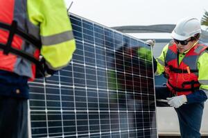 Workers Technicians are working to construct solar panels system on construction site. engineers are checking before Instal solar photovoltaic panel system. Renewable clean energy technology concept. photo