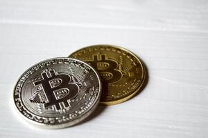 Silver and golden bitcoins on a white background. photo