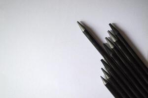 The set of grey pencils on a white background. Tools for drawing on the desk. photo