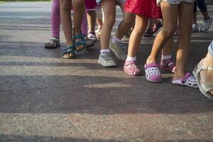 Children's feet one by one. photo