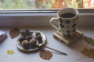 Breakfast with coffee and snacks on the window sill. photo