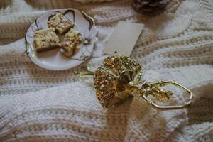 A cup of coffee, woolen sweater and Christmas decorations. Winter still life. photo