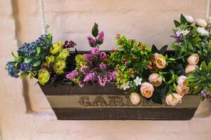 Beautiful flowers in the wooden pot. photo