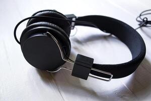 Black headphones on a white table. photo