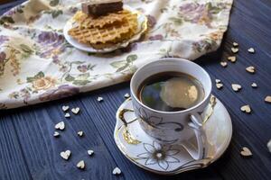 A cup of coffee and dessert on a rustic table. photo