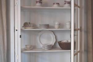 Open cupboard with dishes. photo