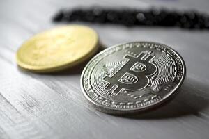 Silver and golden bitcoins on a white background. photo