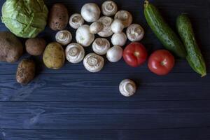 Vegetables on a rustic table. Organic ingredients for cooking. photo