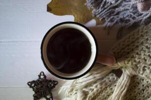 Autumn leaves and hot tea on the white wooden desk. Autumn background with copy space. photo