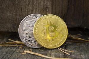 Golden and silver bitcoins on the wooden background. The coins of cryptocurrency. photo