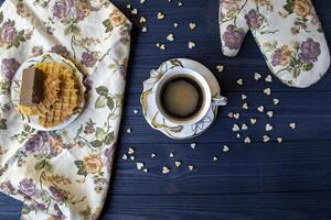 A cup of coffee and dessert on a rustic table. photo