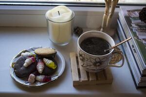 A cup of coffee and cakes on a table. photo