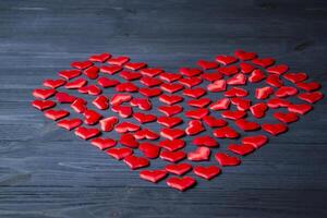 Red love hearts on a blue wooden background. Valentine's Day 2019. Background for greeting card. photo