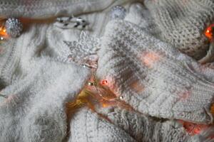 White knitted texture with decor. Soft clothes. Winter season. photo