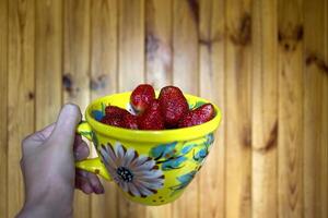 A mug of ripe strawberries. The healthy food. photo