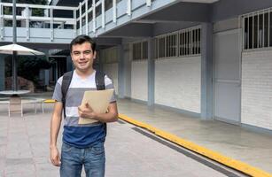 A student holding a book in a school hallway. photo