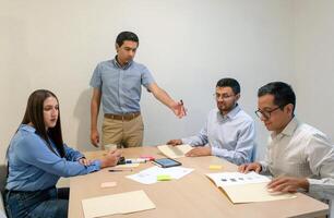 A group of people sitting around a table photo