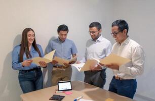 Group Of People Looking At Papers photo