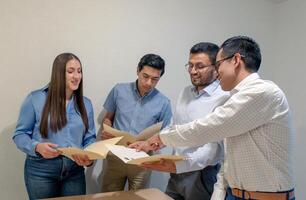 Group of people looking at papers in the office during working hours photo