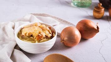 Homemade onion soup with croutons and cheese in a bowl on the table web banner photo