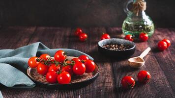 Branch of fresh ripe cherry tomatoes on a plate on the table web banner photo