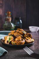 Sliced grilled mushrooms with herbs on a plate on the table vertical view photo