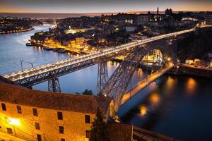 Night view of the historic city of Porto, Portugal with the Dom Luiz bridge photo
