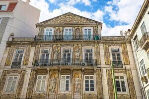 Lisbon buildings with typical traditional portuguese tiles on the wall in Lisbon, Portugal photo