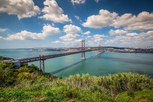 The 25 de Abril Bridge is a bridge connecting the city of Lisbon to the municipality of Almada on the left bank of the Tejo river, Lisbon photo