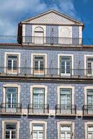 Lisbon buildings with typical traditional portuguese tiles on the wall in Lisbon, Portugal photo