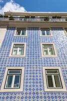 Lisbon buildings with typical traditional portuguese tiles on the wall in Lisbon, Portugal photo