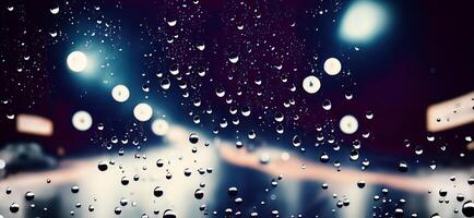 Rain shower on car windshield or car window and blurry road in background. photo